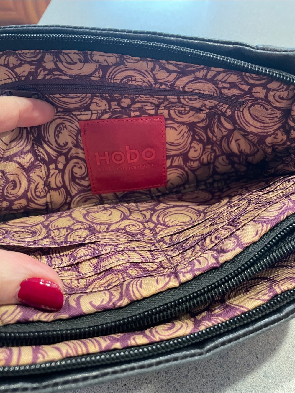 HOBO Black Leather Wristlet with Purple and Cream Patterned Interior